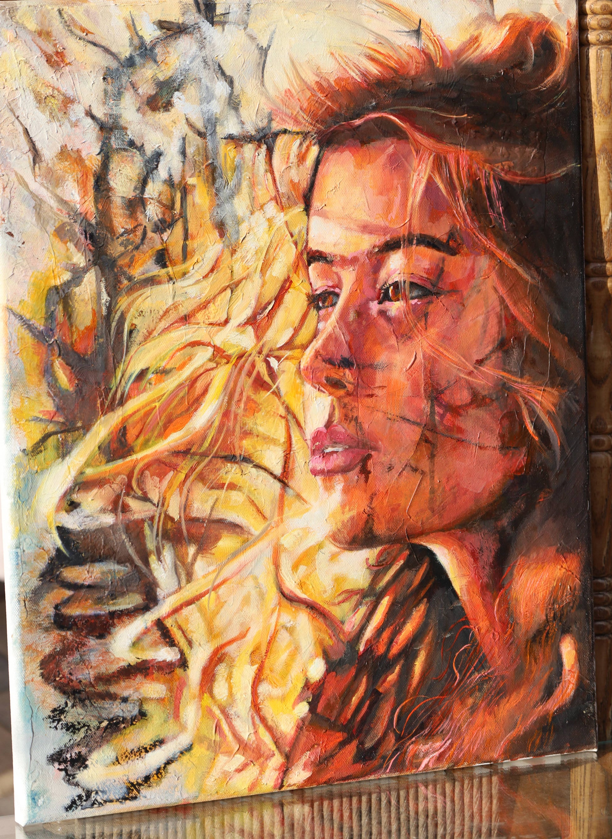Artistic depiction of a woman's face with warm colors and abstract elements.
